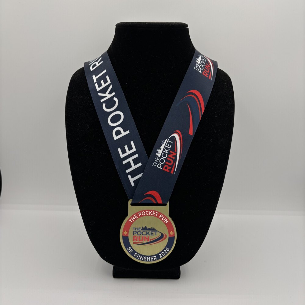 The Pocket Run 5K finisher medal on its navy printed ribbon
