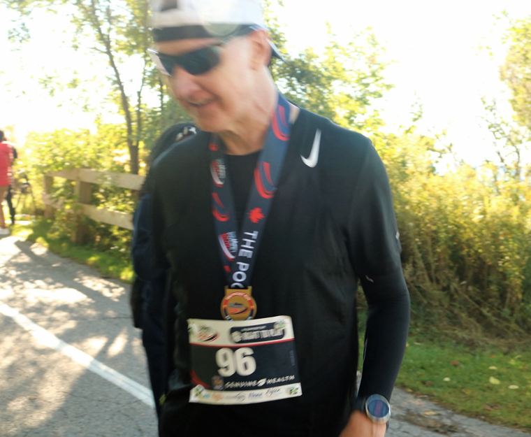 Runner in bib 96 wearing a finisher medal