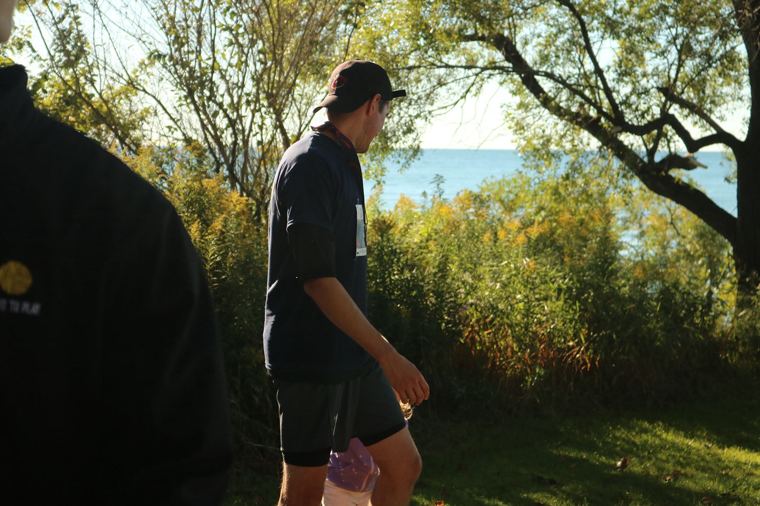 Runner walking the trail by the lake