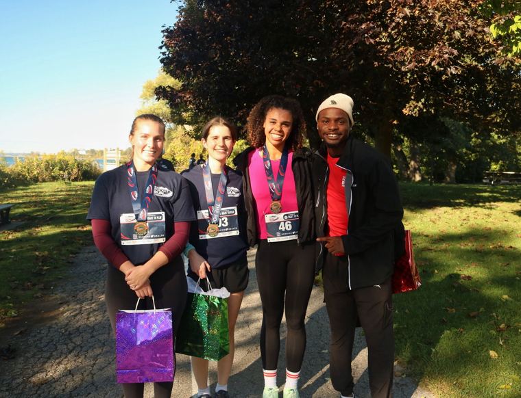 Group of finishers posing on the path