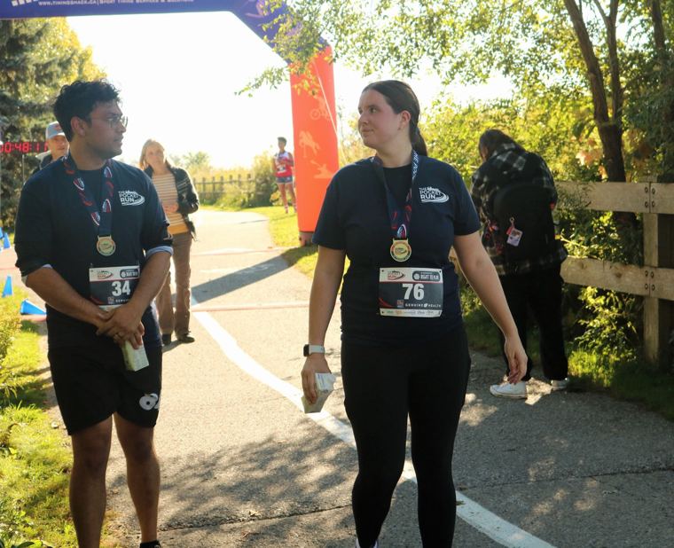 Two finishers wearing medals on the trail