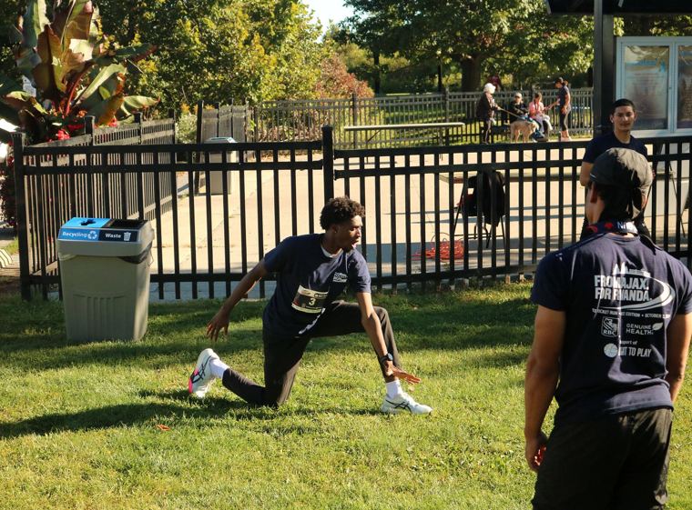 Two participants warming up on the grass