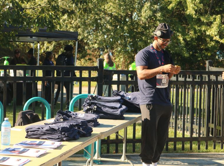 Participant at the shirt and program table