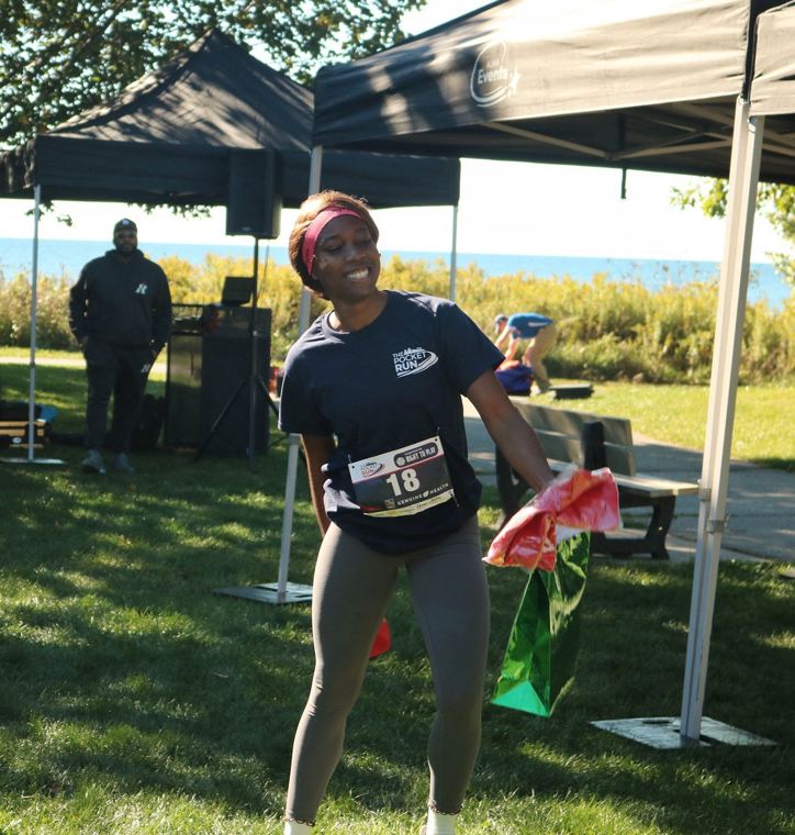Participant with a gift bag under a tent