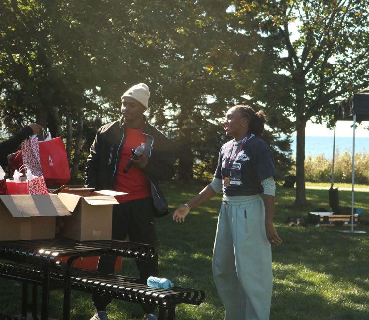 Volunteer and participant at the gift bag table
