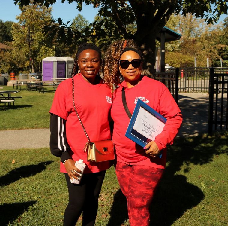 Two family members holding the Mayor's certificate
